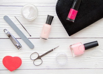 manicure set and nail polish on wooden background