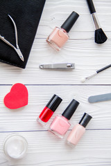 manicure set and nail polish on wooden background