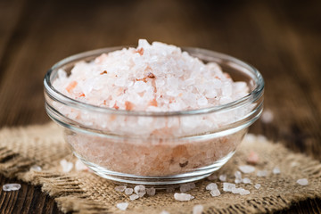 Portion of Himalayan Salt on wooden background (selective focus)