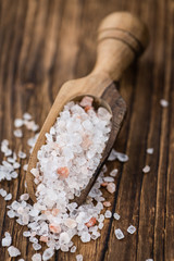 Portion of Himalayan Salt on wooden background (selective focus)