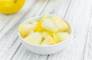 Portion of Yellow Honeydew Melon on wooden background (selective