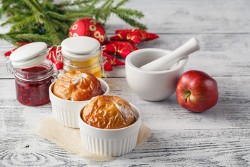 Christmas background of homemade oven baked apples, spices, nuts