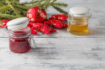 Christmas jam jar with festive decoration on white wooden backgr