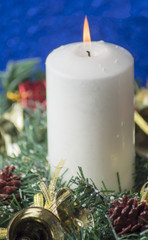 Obraz na płótnie Canvas Christmas Decorations With Lit Candle