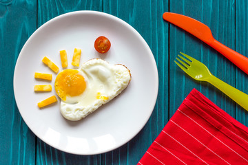 sunshine fried eggs breakfast for kid on blue background