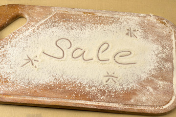 inscription sale on a white flour spills on board