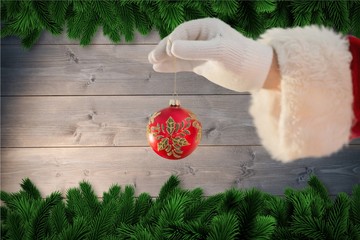 Santa claus holding christmas bauble