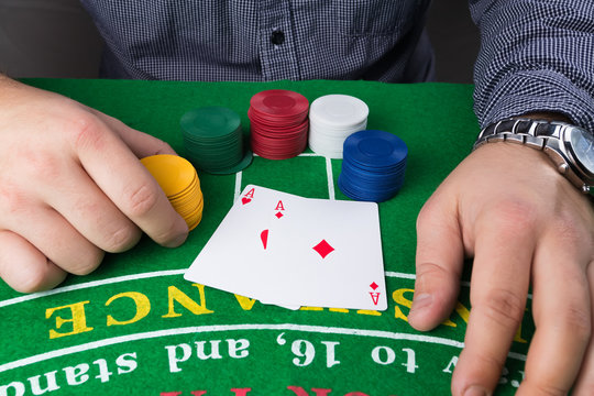 Casino chips and cards on green table.