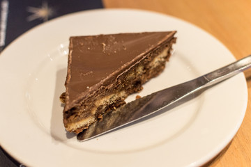 Chocolate Tiffin Cake With Knife On White Plate B