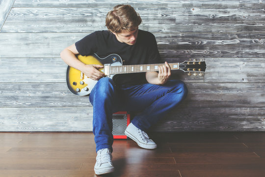 Handsome boy with electric guitar