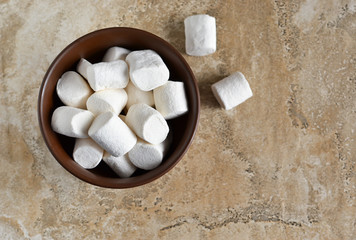 Vanilla marshmallow in a plate on a concrete background