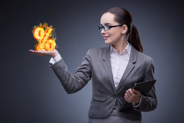Businesswoman with percent sign in high interest concept