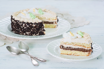 Creamy cake on plate on table on light background