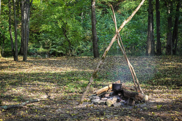 Cauldron on fire in forest