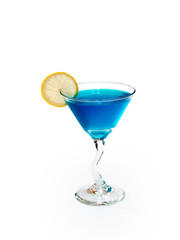 Glass of alcoholic blue drink with lemon on white background.