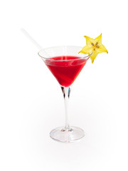 Glass of red alcoholic drink with carambola on white background