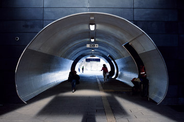 persons goes through modern underpass