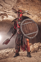 Naklejka premium Attack of powerful knight in heavy armor on the dungeon backgrou