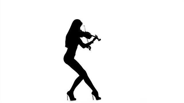 Girl violinist playing the fiddle. Silhouette