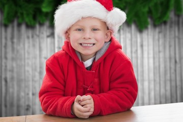 Boy in santa hat smiling at camera