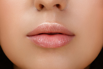 Perfect natural lip makeup. Close up macro photo with beautiful female mouth. Plump full lips. Close-up face detail. Perfect clean skin, light fresh lip make-up. Beautiful spa tender lip