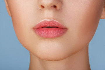 Perfect natural lip makeup. Close up macro photo with beautiful female mouth. Plump full lips. Close-up face detail. Perfect clean skin, light fresh lip make-up. Beautiful spa tender lip