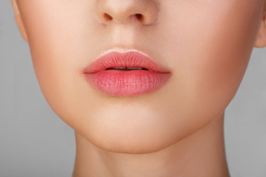 Perfect natural lip makeup. Close up macro photo with beautiful female mouth. Plump full lips. Close-up face detail. Perfect clean skin, light fresh lip make-up. Beautiful spa tender lip
