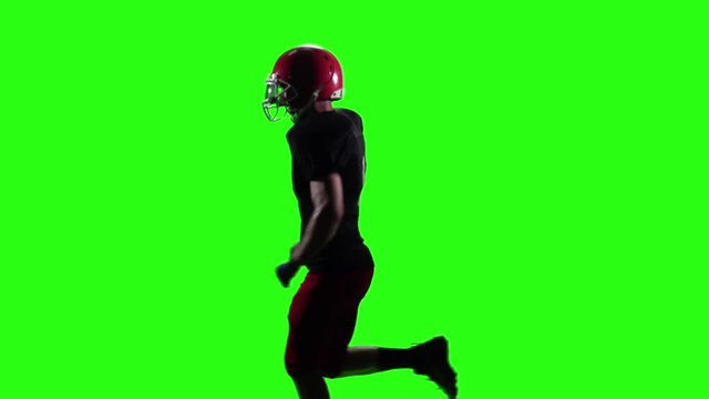 Rugby player running in the red helmet. Green screen. Slow motion