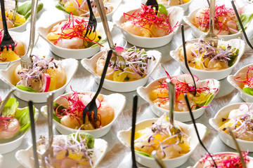 Colorful mini snacks, appetizers in white cups. Healthy diet or