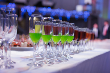 Catering banquet table with baked food snacks, sandwiches, cakes, cups and plates, self serve, open...