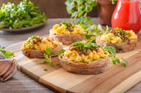 Scrambled eggs on toast with herbs