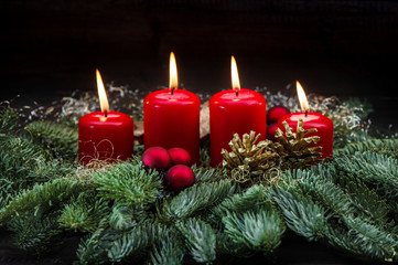 Advent decoration red burning candles christmas tree branches