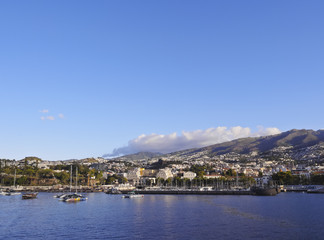 Fototapeta na wymiar Portugal, Madeira, Funchal, Cityscape viewed from the ferry leaving the port..