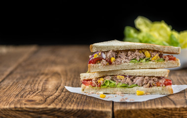 Wooden table with a Tuna Sandwich (selective focus)