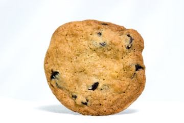 Front view of golden brown homemade chocolate chip cookie on a white background.