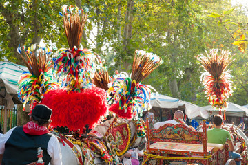 Ornamental and colorful feather on a sicilan cart during a folk festival