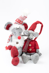 Cute vintage toy -  mouses sitting on the floor. Mouses wearing winter  accessories - Christmas hat and scarf. Christmas decoration. Isolated, white background.