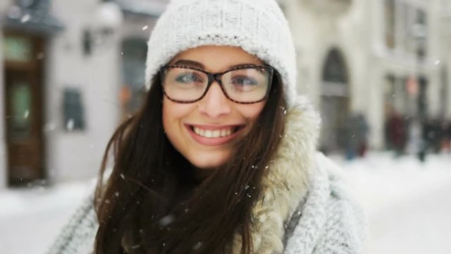 happiness, winter holidays, christmas, beverages and people concept - Attractive beautiful lady posing and flirting on camera over snowy city background