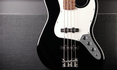 Fototapeta na wymiar electric bass guitar on speaker background