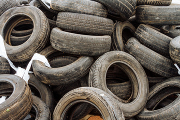 Mound of used car tires in a junkyard