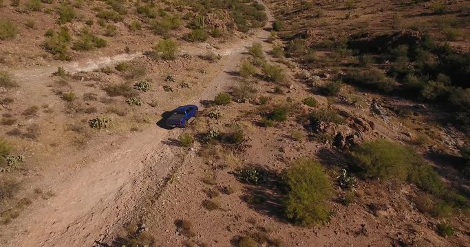 Flying over a single 4x4 truck off-roading on an Arizona desert trail.	 	