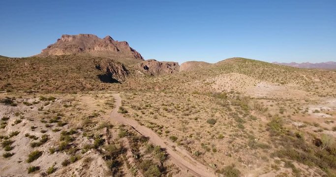 A high angle aerial daytime establishing shot of the Arizona desert.  	