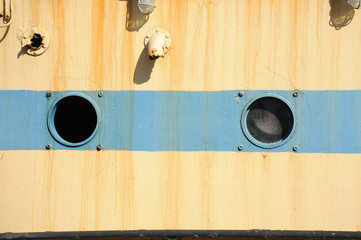 Portholes on a tanker displayed outdoors.