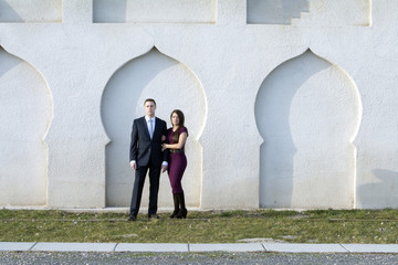 couple in the sunrise against a decorative wall