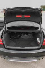 clean empty trunk of black sedan on the street