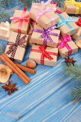 Wrapped gifts with ribbons for Christmas, spices and spruce branches, copy space for text