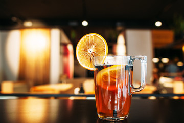 Glass of tasty citrus on restaurant table. Hot drink with orange slice. Bar, party, recipe, refreshment , winter beverage concept