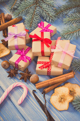 Vintage photo, Wrapped gifts with ribbons for Christmas, spices and spruce branches