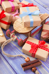 Wooden sled and wrapped gifts with ribbons for Christmas or other celebration