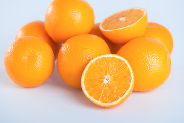 Fresh orange and cut in half on white background